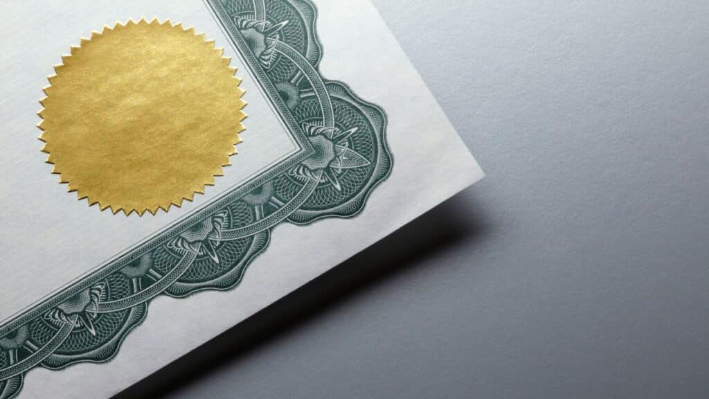 Imagem de um certificado com selo dourado e borda verde detalhada