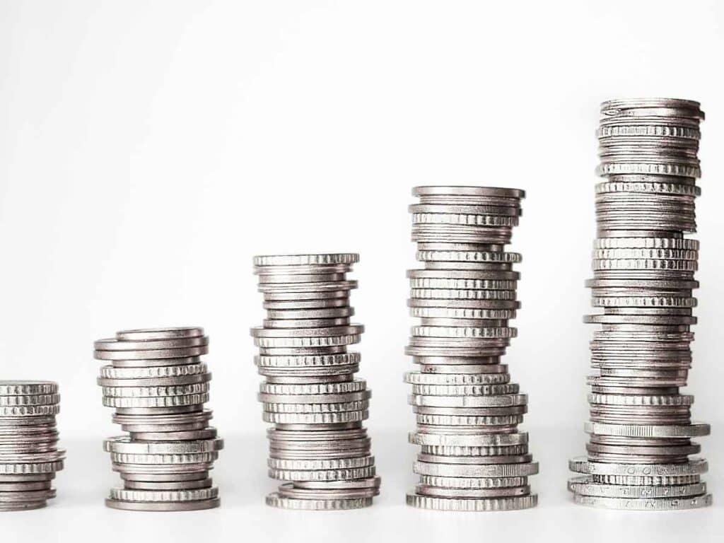 Várias pilhas de moedas prateadas alinhadas em ordem crescente